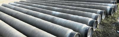 Cement coated pipes stacked in yard